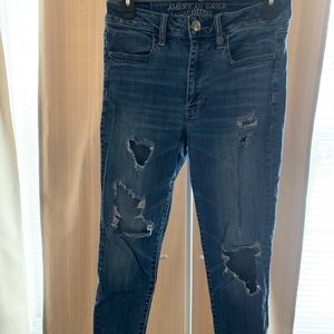 Medium wash skinny jeans, distressed